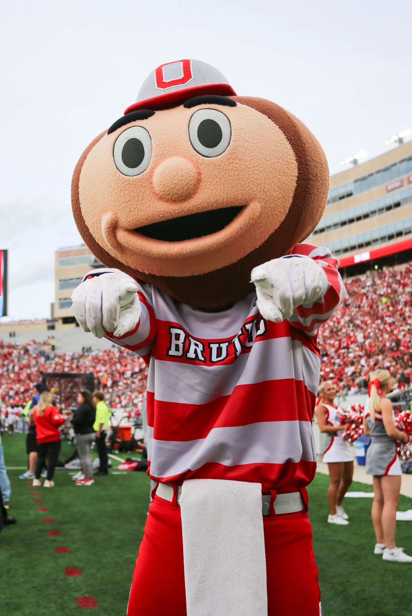 Brutus Buckeye points toward the camera from the Ohio Stadium sideline