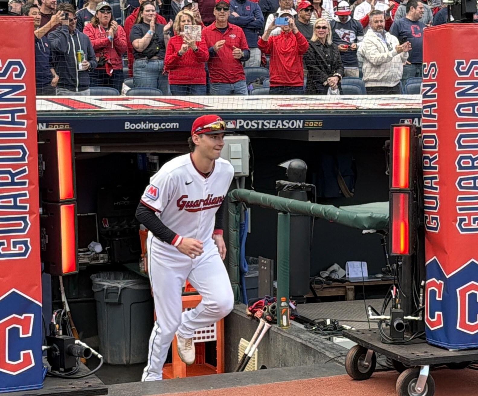 Chase DeLauter in a white Guardians uniform emerging from the dugout during the 2026 postseason