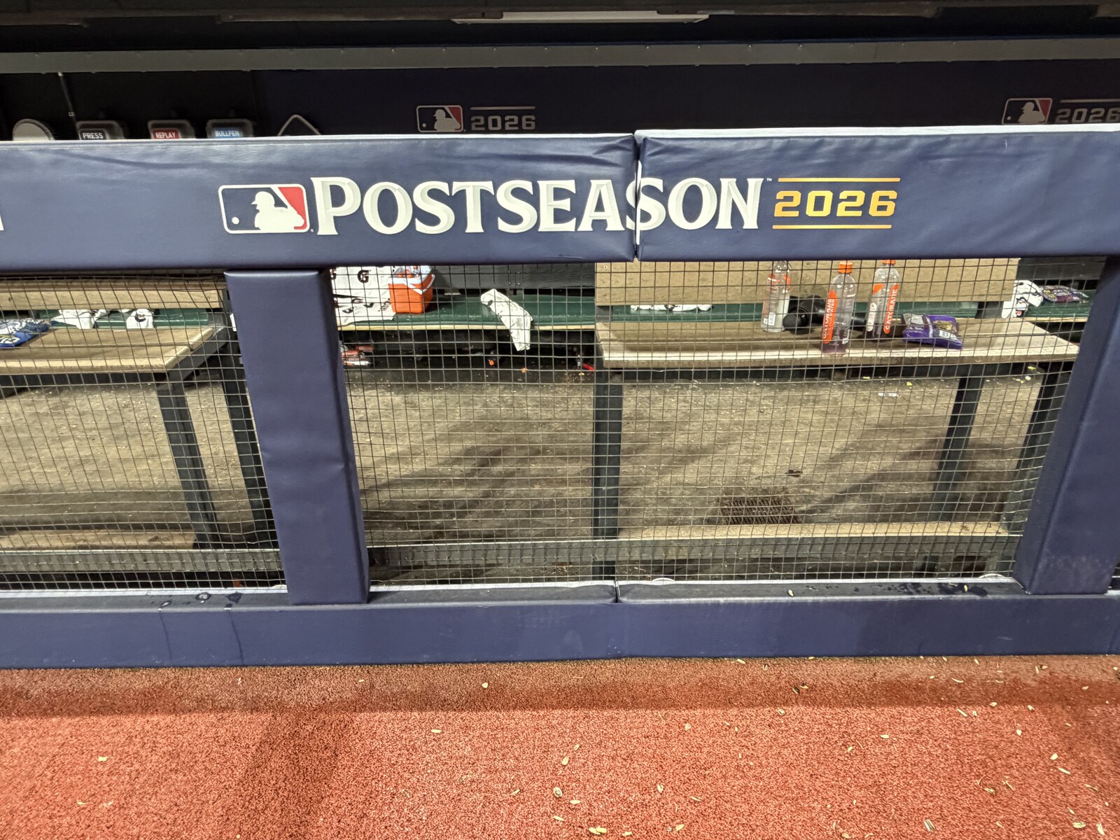 A baseball dugout railing displaying the MLB Postseason 2026 banner