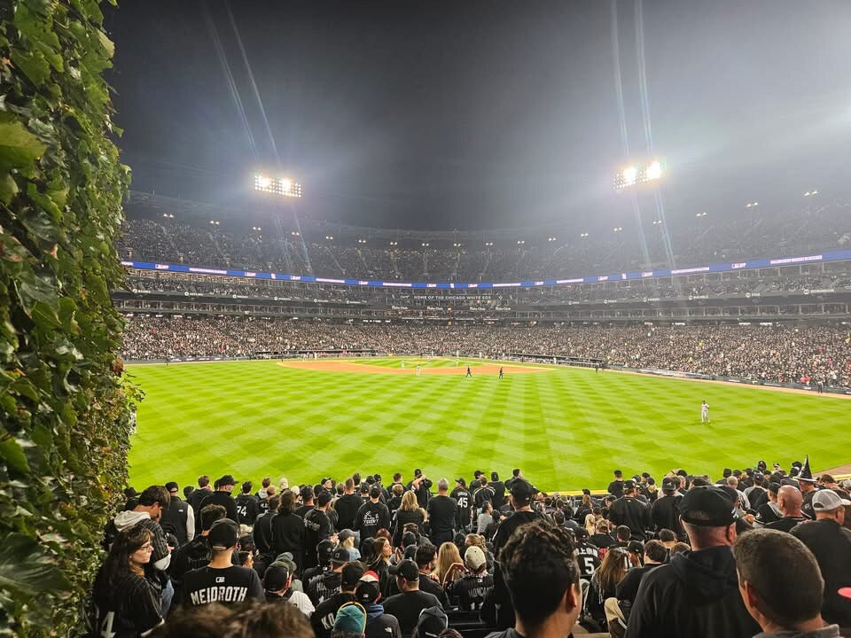 Fans watch the Cleveland Guardians and Chicago White Sox play at a packed Rate Field under the lights during ALDS Game 4