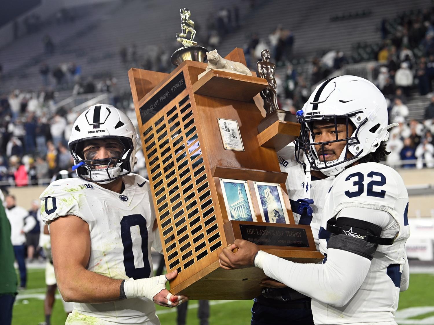 Penn State linebackers Dominic DeLuca and Keon Wylie holding the Land Grant Trophy after the November 15, 2025 game at Michigan State