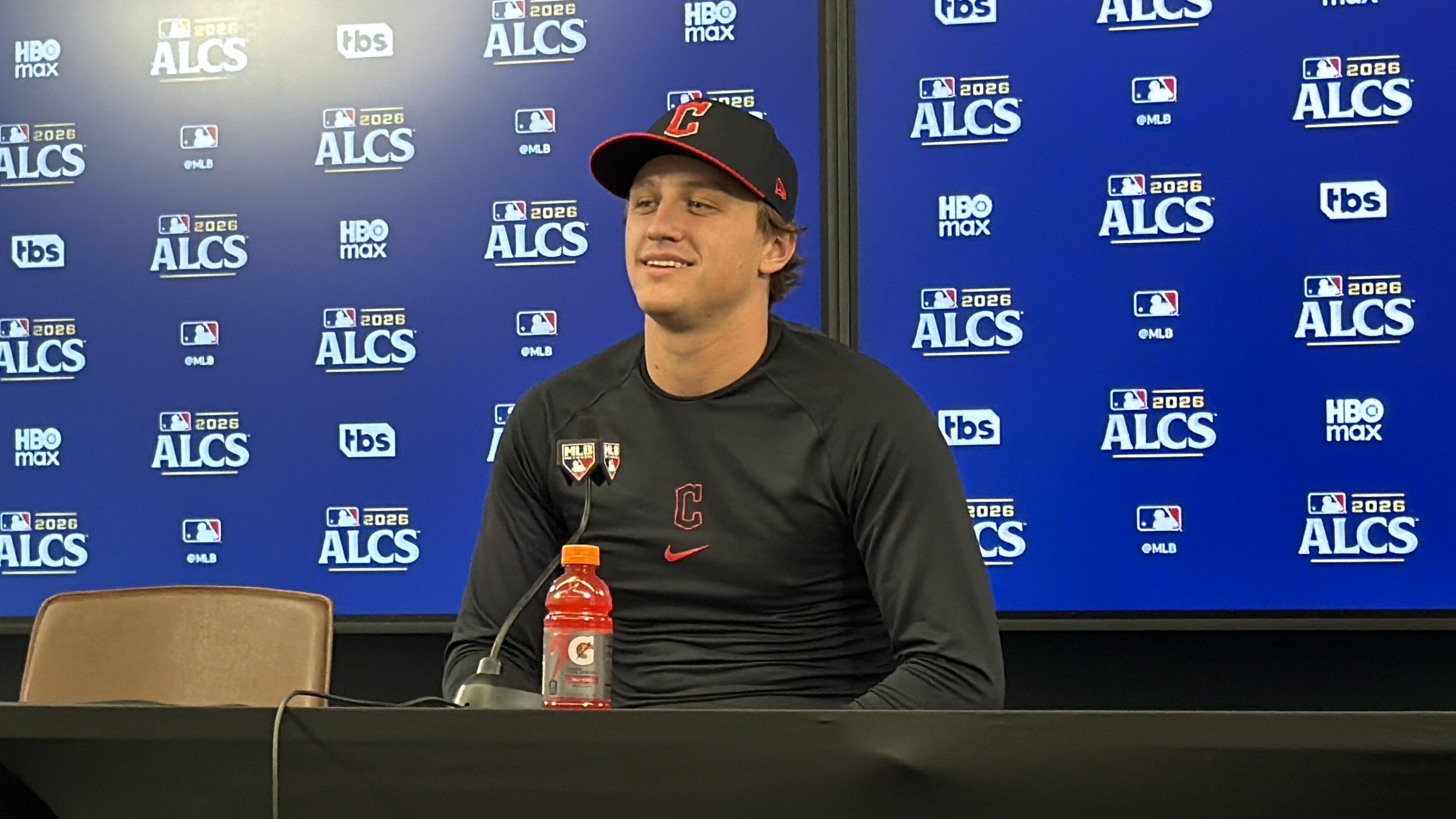Petey Halpin in a Cleveland Guardians cap at a press conference in front of the 2026 ALCS backdrop