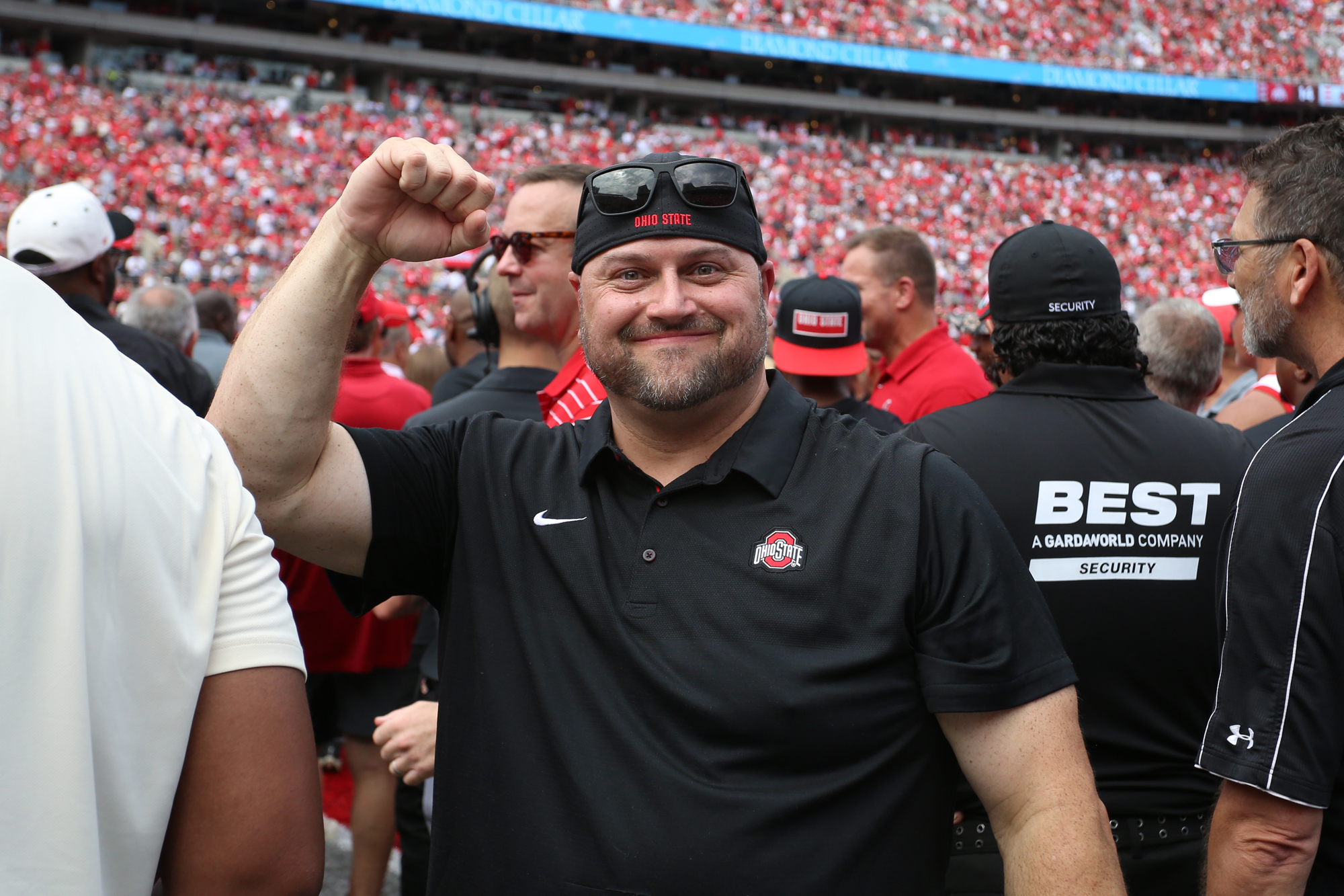 Former Ohio State football player Tyler “Tank” Whaley raises his fist on the field at Ohio Stadium